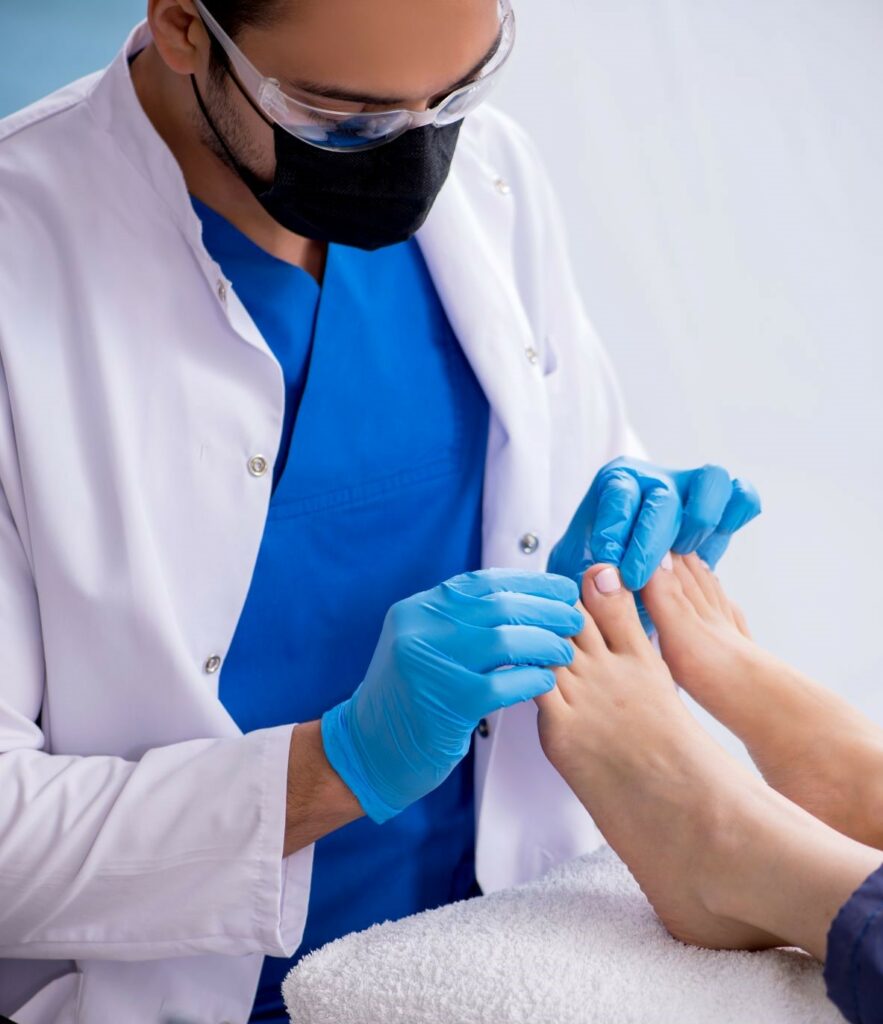 Doctor examining a patients feet.